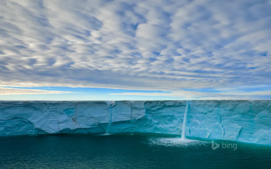 Meltwater creates waterfalls on an ice cap, Svalbard Archipelago, Norway