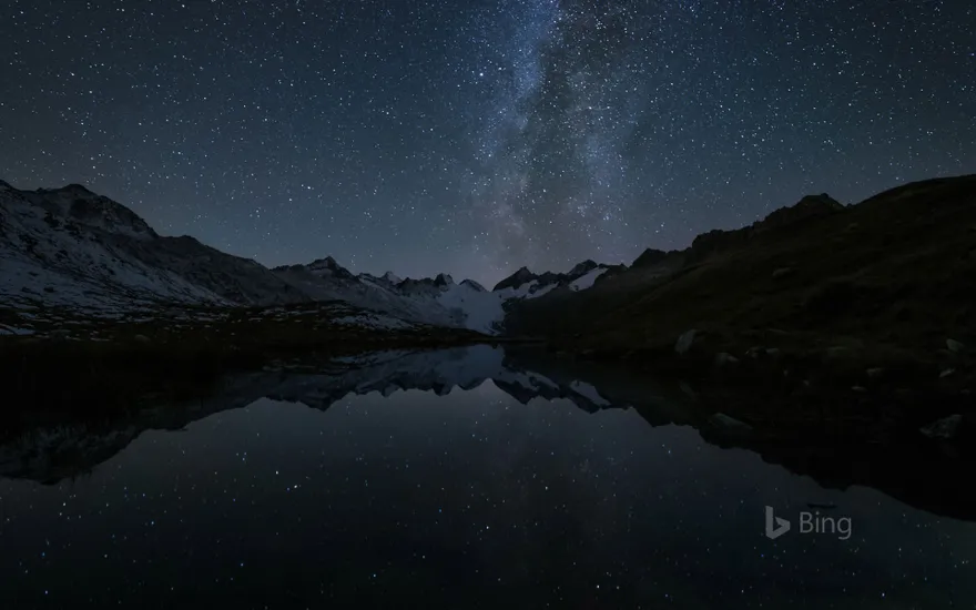 Stars reflected in the Totensee, a mountain lake at Grimsel Pass, Switzerland