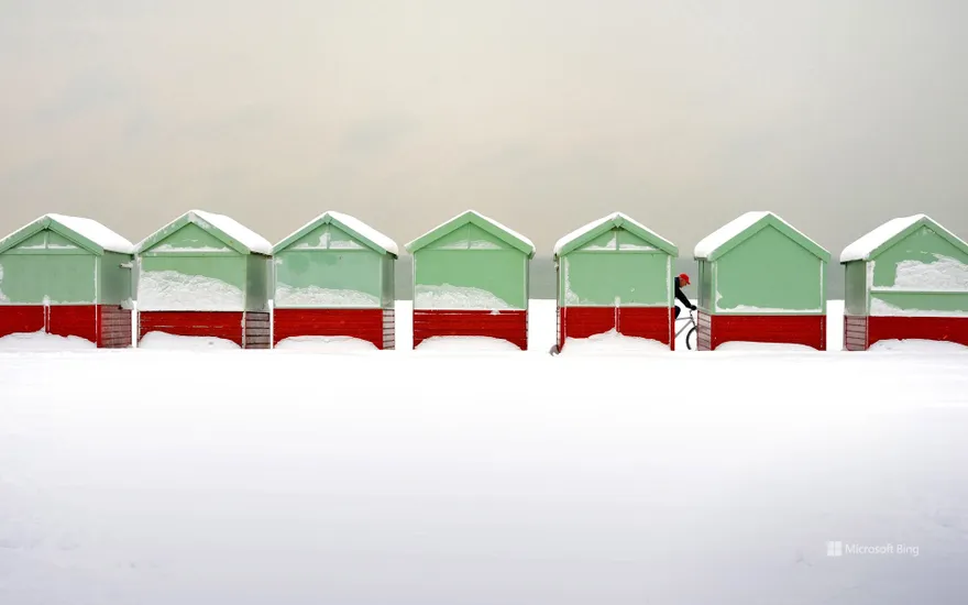 Beach huts covered in snow in Brighton and Hove, England