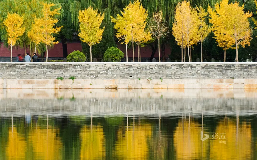 China, Beijing, autumn reflected in the moat of the Forbidden City