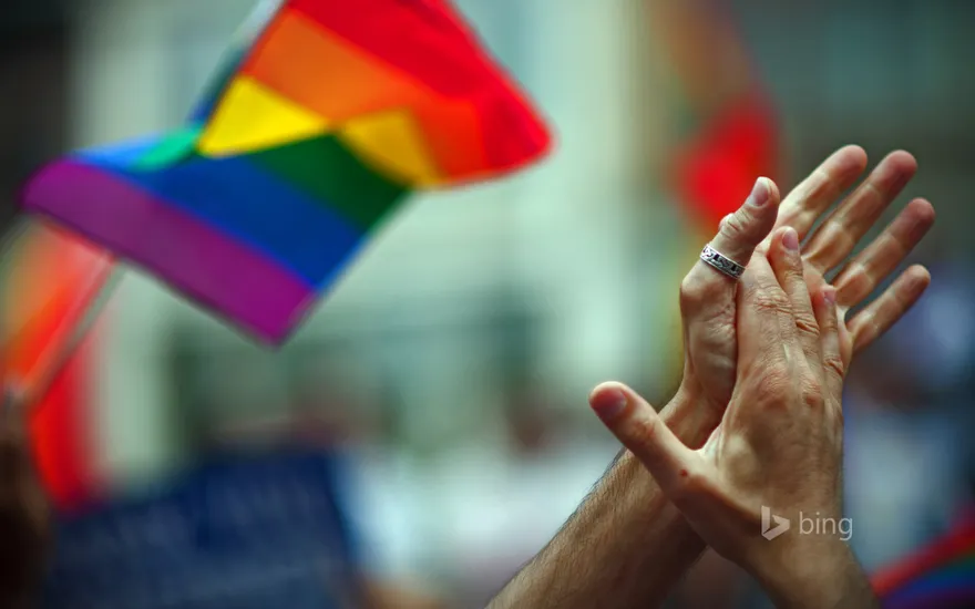 Rainbow flag and clapping hands