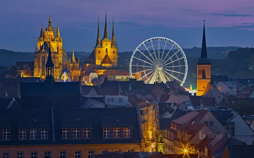 View of the Ferris wheel, Erfurt Cathedral and St. Severus Church during Oktoberfest in Erfurt, Germany