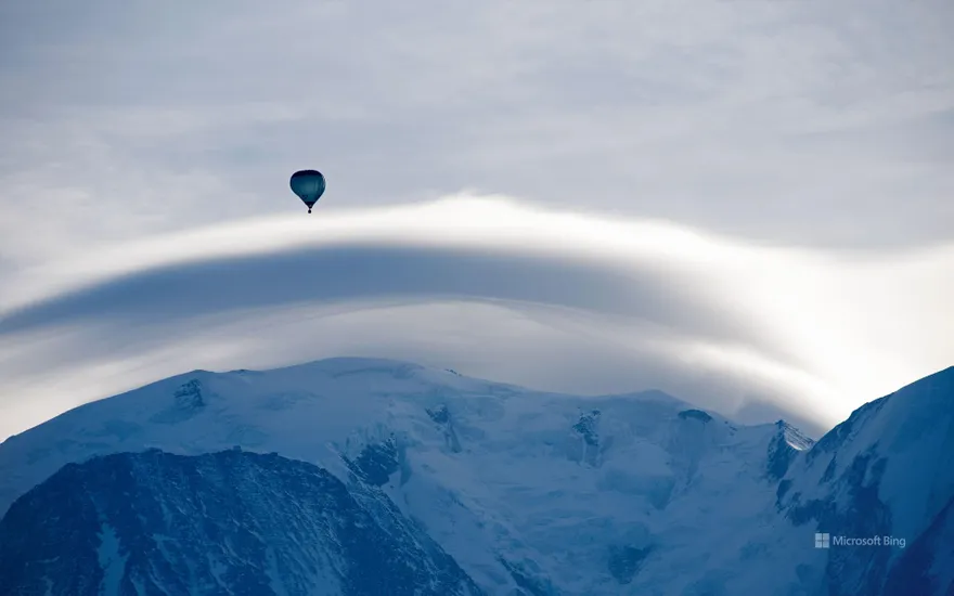 Mont Blanc, topped by a lenticular cloud and a hot air balloon, Haute-Savoie