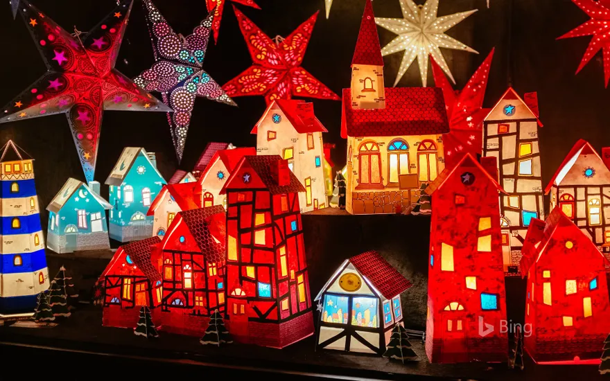 Luminous paper houses and poinsettias at a Christmas market in Hanover, Lower Saxony