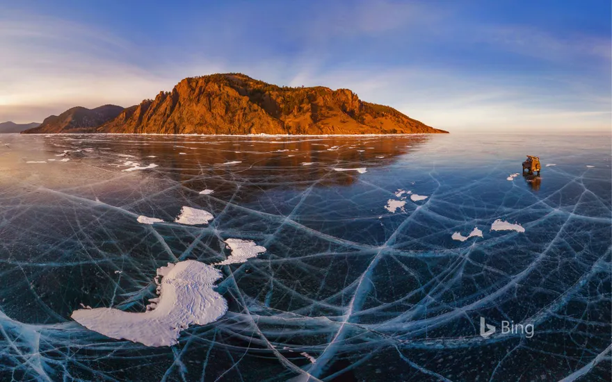 Aerial view of car crossing over the frozen surface of Lake Baikal, Russia