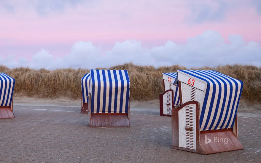 Beach chairs in the sunset on the north beach of the island of Borkum, Lower Saxony