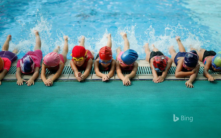Children are participating in swimming training in the gym of Chen Jinglun Sports School, Hangzhou, China