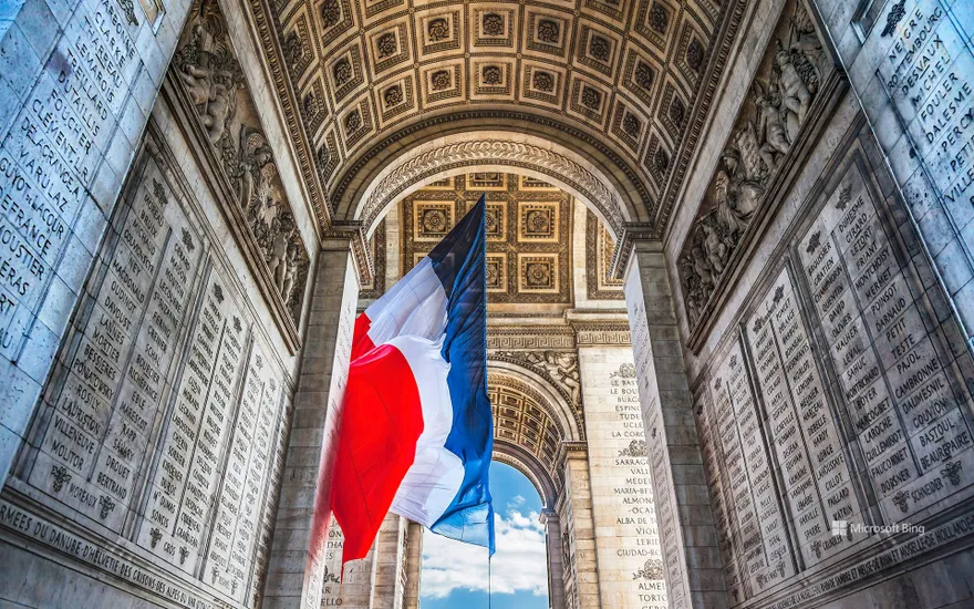 French flag under the Arc de Triomphe, Paris, France