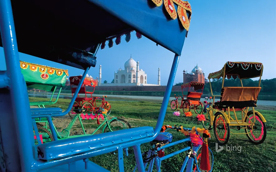 Cycle rickshaws and view of Taj Mahal in Agra, India