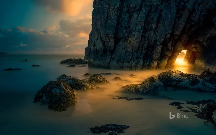 Light from sunrise through a sea cave on the Isle of Skye, Scotland