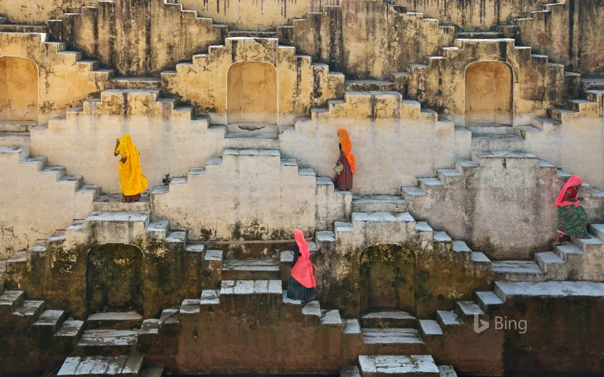 Women climbing a stepwell near Amber Fort in Jaipur, Rajasthan, India