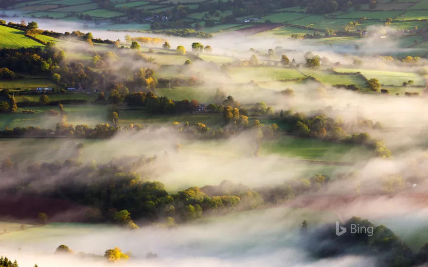 Mist blows over rolling countryside near Talybont-on-Usk in Brecon Beacons National Park, Wales